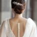 Bride in wedding dress from behind with glam bun hairstyle outdoors