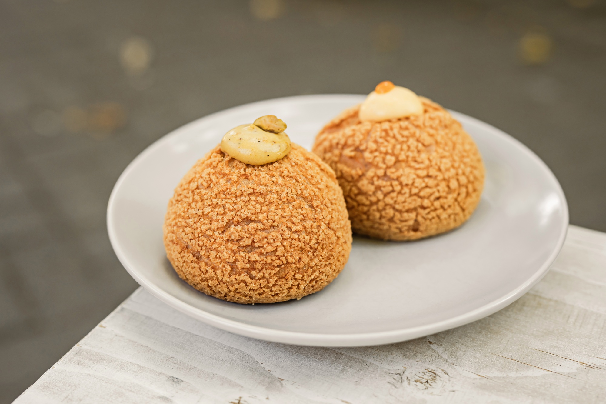 Choux au Craquelin french pastry or cream puff dessert on a plate