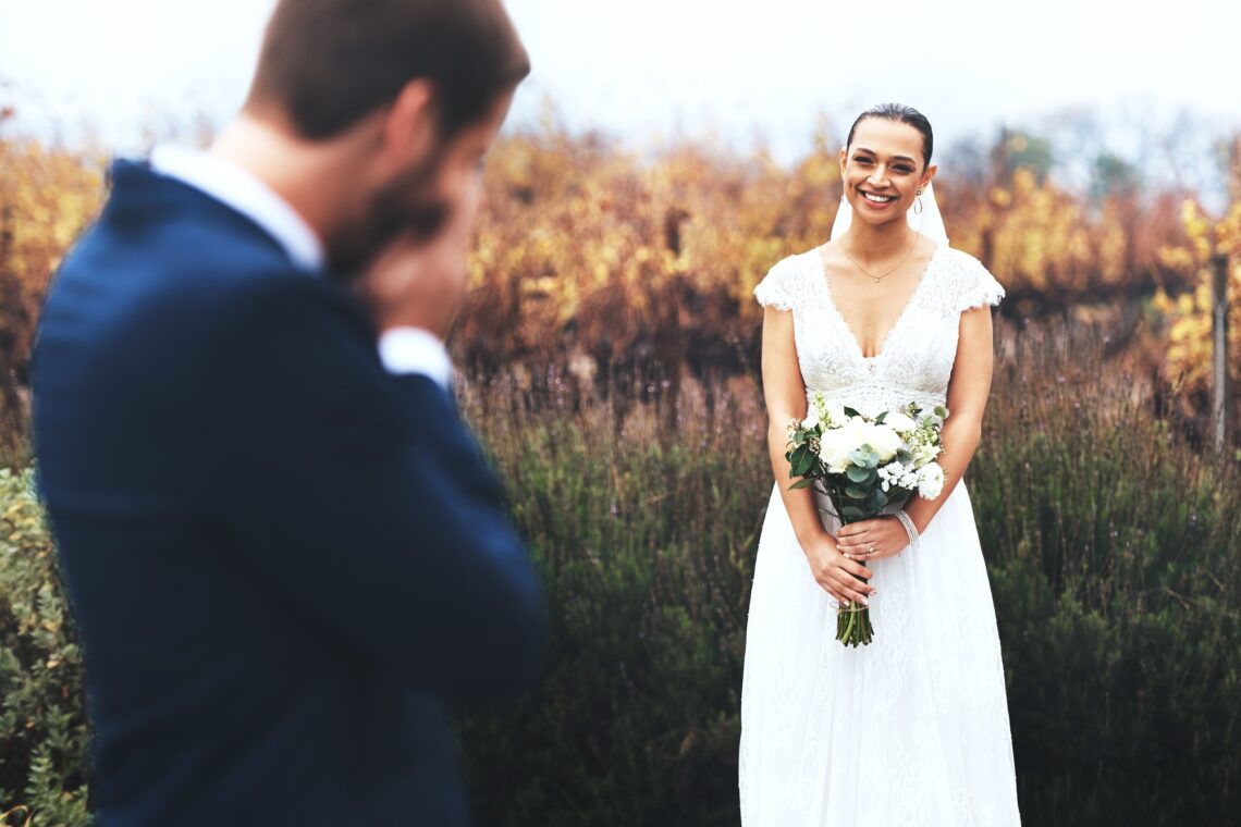 Shot of a bridegroom crying while looking at his beautiful bride on their wedding day