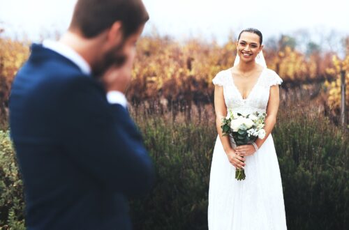 Shot of a bridegroom crying while looking at his beautiful bride on their wedding day