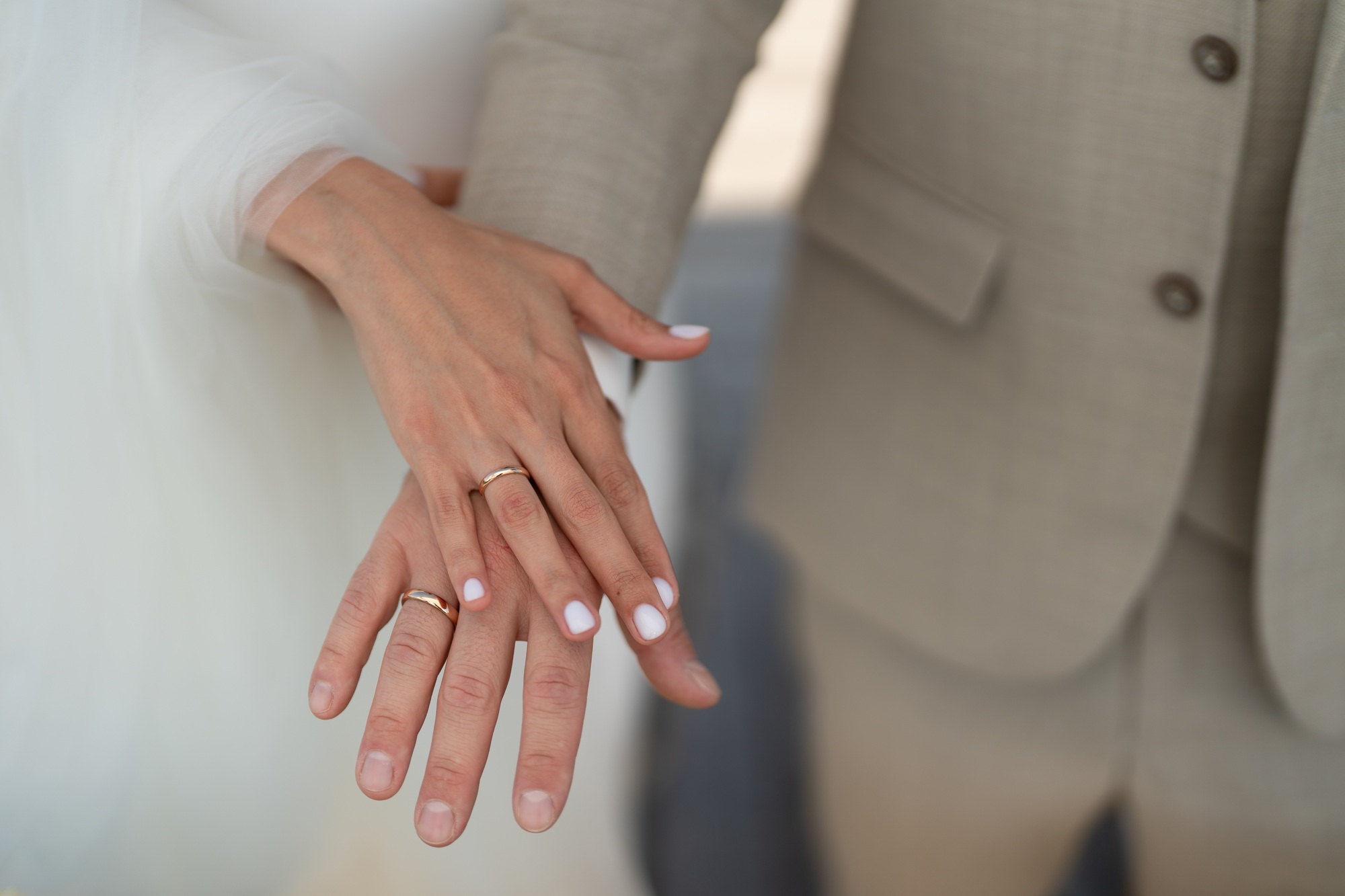 The bride and groom show their rings at the civil wedding